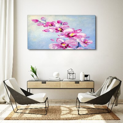 Vászonkép Rózsaszín orchideák kék alapon