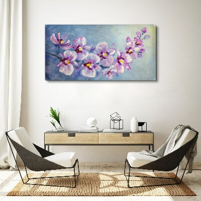 Vászonkép Virágos orchideák a kék háttér