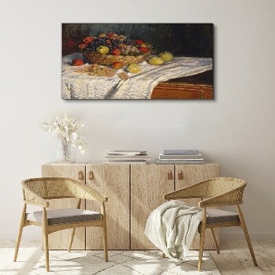 Vászonkép Gyümölcskosár fehér terítőn