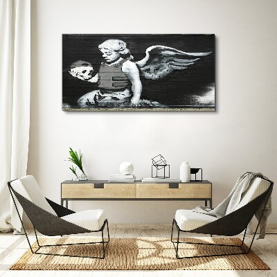 Vászonkép Angyal egy koponyával a graffiti háttérben