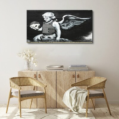 Vászonkép Angyal egy koponyával a graffiti háttérben