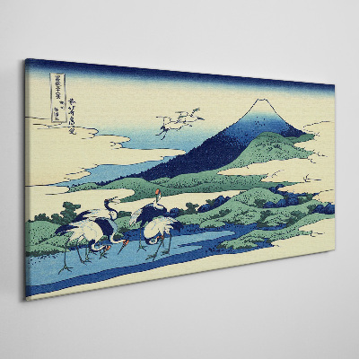 Vászonkép Daruk egy hegy mellett