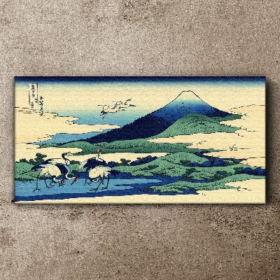 Vászonkép Daruk egy hegy mellett