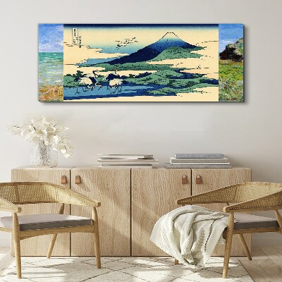 Vászonkép Daruk egy hegy mellett