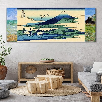 Vászonkép Daruk egy hegy mellett