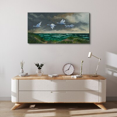 Vászonkép Hattyúk repülése a tenger felett