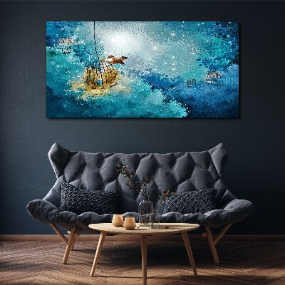 Vászonkép Egy ketrecbe zárt madár az égen