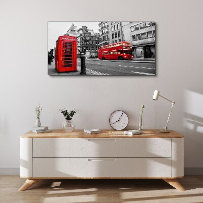 Vászonkép Piros telefon egy szürke városban