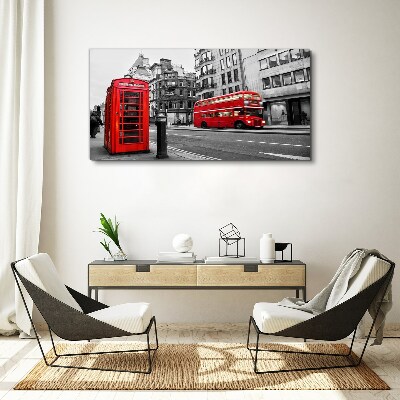 Vászonkép Piros telefon egy szürke városban