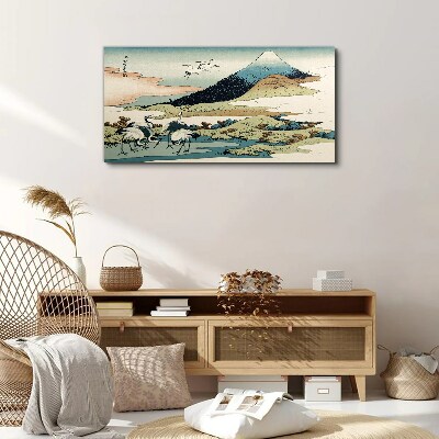 Vászonkép Daruk egy hegy mellett