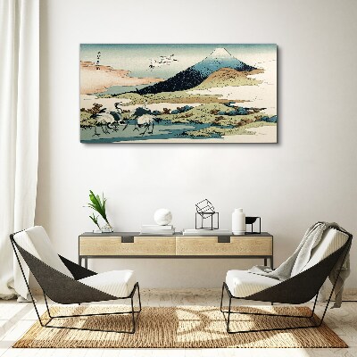 Vászonkép Daruk egy hegy mellett