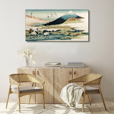 Vászonkép Daruk egy hegy mellett