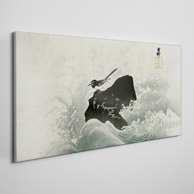 Vászonkép Madár egy sziklán a hullámokban