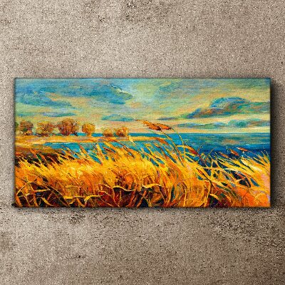 Vászonkép Arany fű kék ​​víz felett