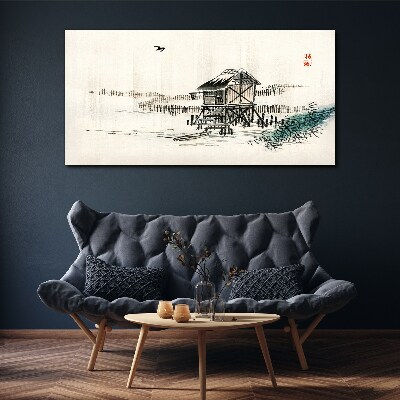 Vászonkép Csendes házikó a víz mellett