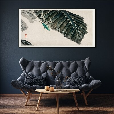 Vászonkép Egy karcsú rovar a leveleken