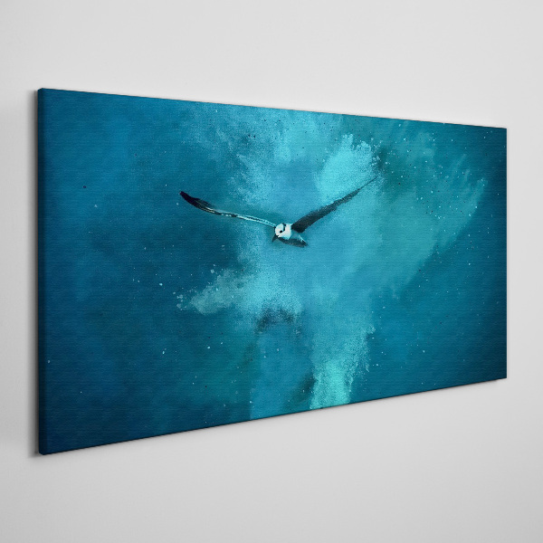 Vászonkép Egy madár a kék térben