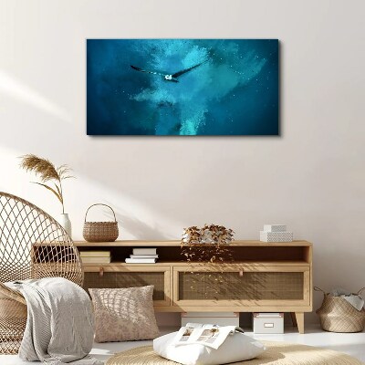 Vászonkép Egy madár a kék térben