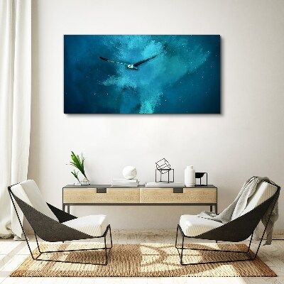 Vászonkép Egy madár a kék térben