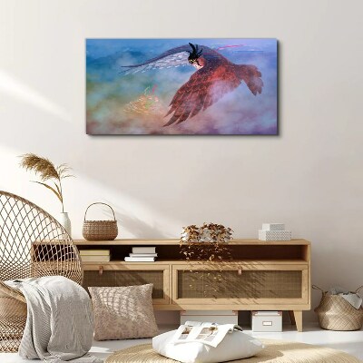 Vászonkép Egy ragadozó madár repülése a felhőkben