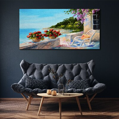 Vászonkép Virágok és a tenger egy napos tájon