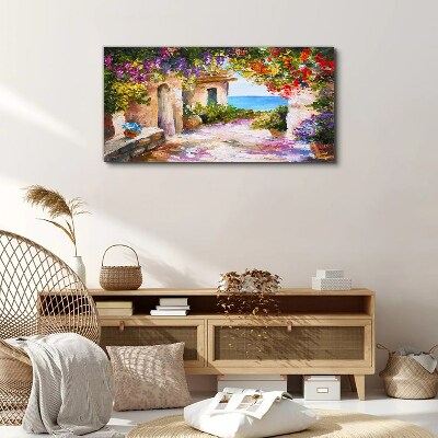 Vászonkép Egy tengerparti falu virágsikátora