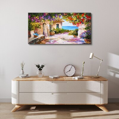 Vászonkép Egy tengerparti falu virágsikátora