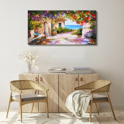 Vászonkép Egy tengerparti falu virágsikátora